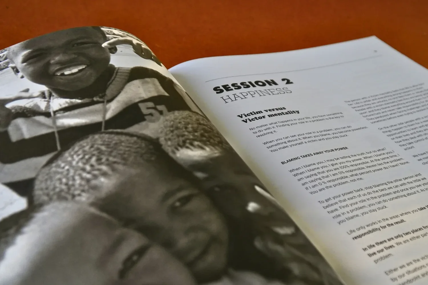 An open Family Affairs workbook on a table, a session page beside photographs of children